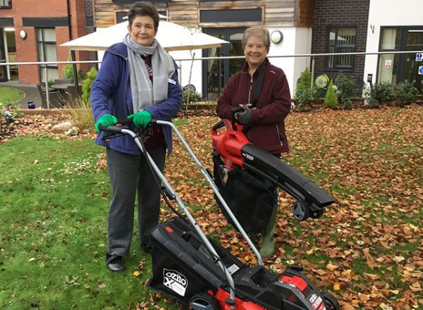 Two women at Rohan Gardens care home with gardening equipment