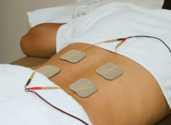 Patient using an FES machine in therapy
