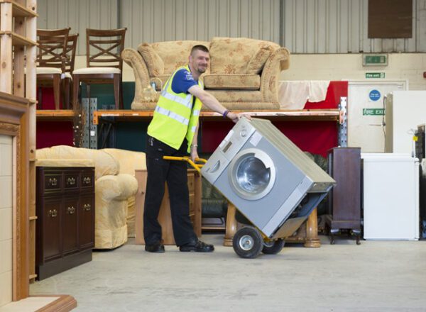 Kennet Furniture, man in high vis jacket in store room of furniture and white goods