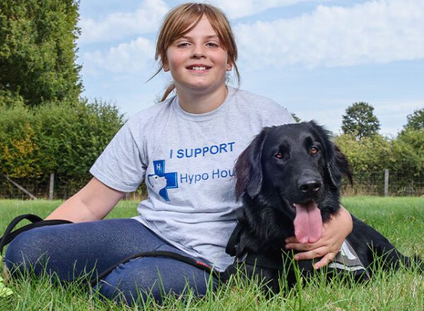 Child in grey Hypo Hounds t-shirt and black dog