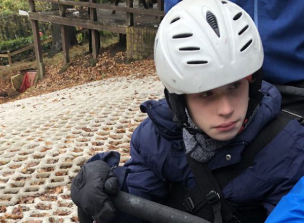 young boy on dry ski slope TAG adaptive snow sports