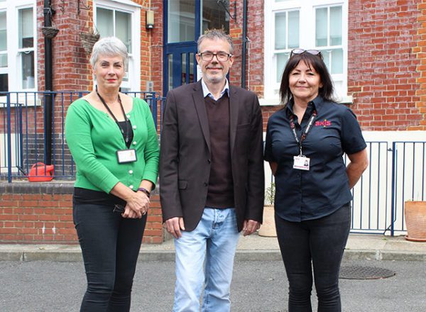 Three people in front of Alcohol and Drug Detoxification Centre with new accessible bathroom